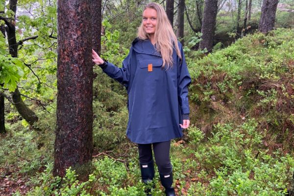 Blæst Bergen Poncho i dark navy med hette og frontlomme, designet for maksimal komfort og beskyttelse mot regn og vind.